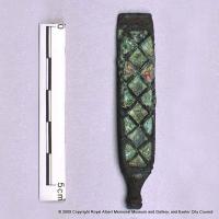 An  enamelled strap–end