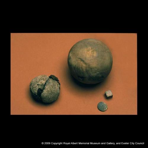 A bowls ball, tennis ball and gaming pieces