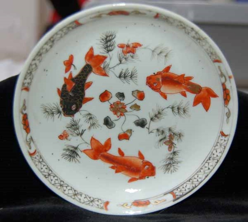 Can you find the saucer decorated with goldfish?